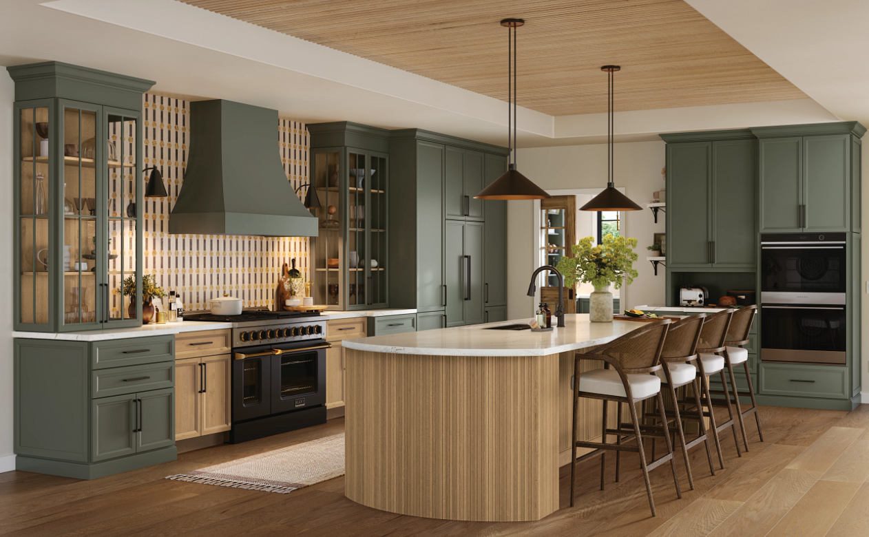 Kitchen with green cabinetry and reeded wood island