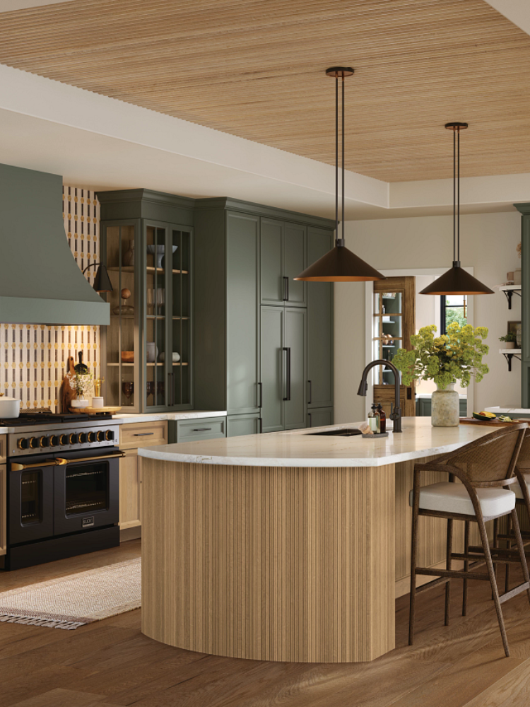 Kitchen with green cabinetry and reeded wood island