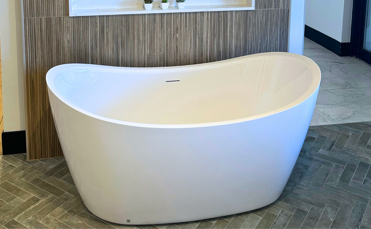 freestanding bathtub with tile flooring and tiled bath surround