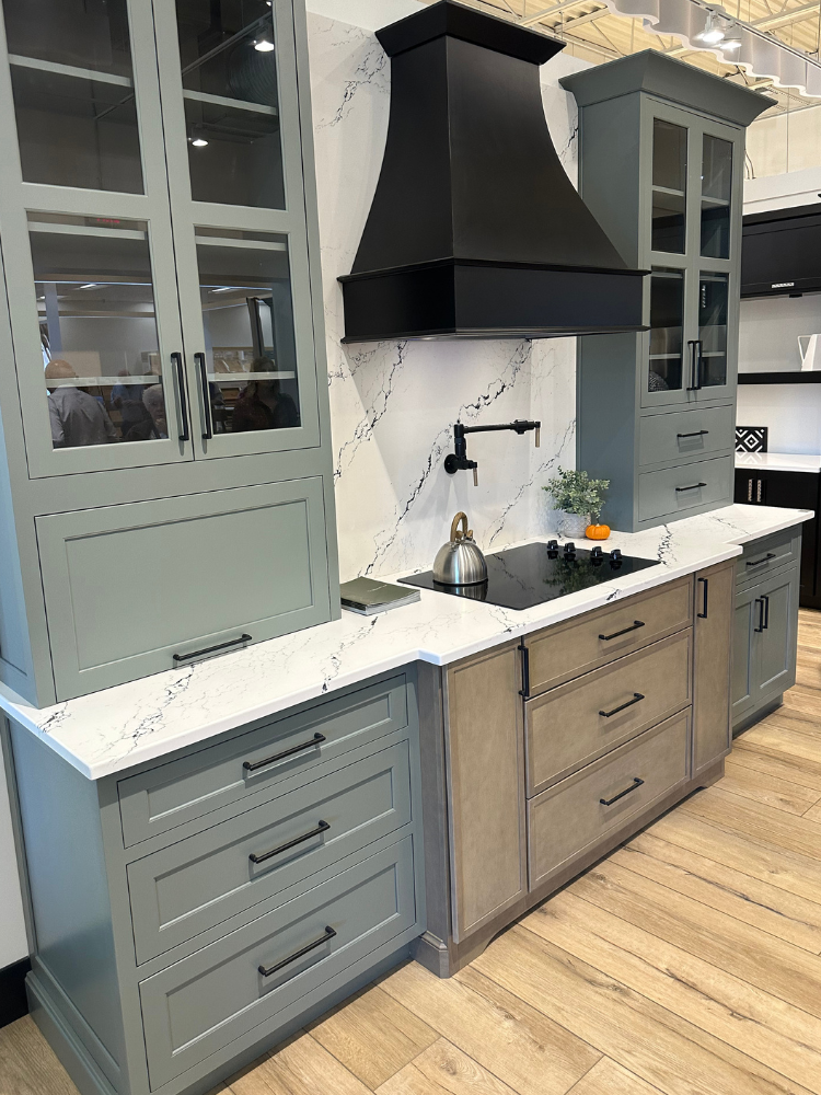 White marble countertops in a kitchen display with green and natural countertops