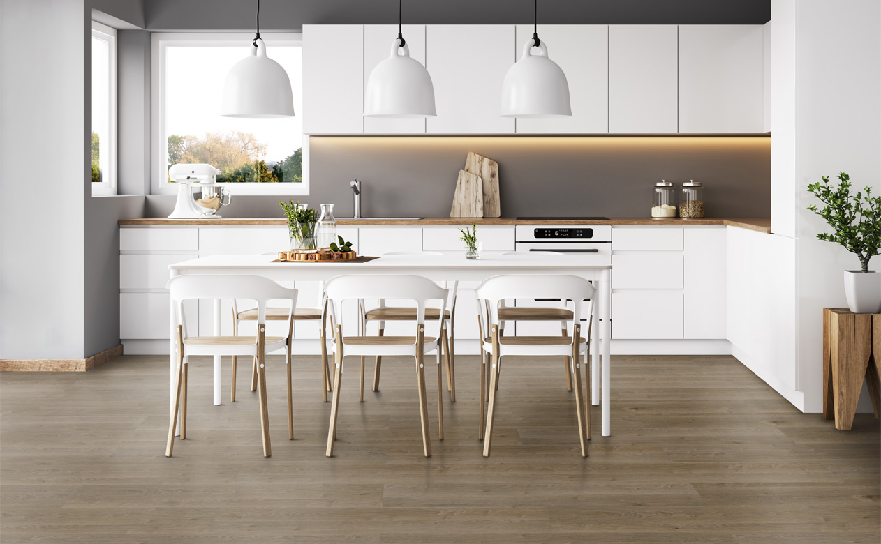 luxury vinyl plank flooring in kitchen with white cabinets and dining table.