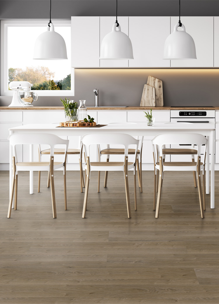 luxury vinyl plank flooring in kitchen with white cabinets and dining table.
